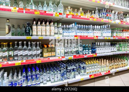 Samara, Russia - 5 maggio 2024: Varie bevande alcoliche in bottiglia forti pronte per la vendita sugli scaffali dei supermercati. Vodka russa diversa imbottigliata sul Foto Stock