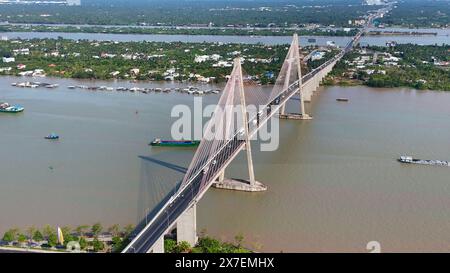 Vista aerea del ponte Rach Mieu, attraversa il fiume Tien, collega Tien Giang con Ben tre, ponte strallato sul delta del Mekong, traffico di barche sull'acqua, veicolo acceso Foto Stock