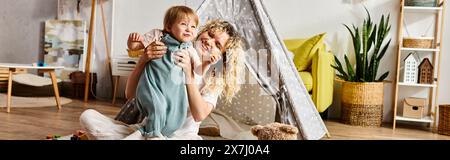 Una madre riccia e sua figlia si impegnano in un gioco fantasioso all'interno di un teepee Foto Stock