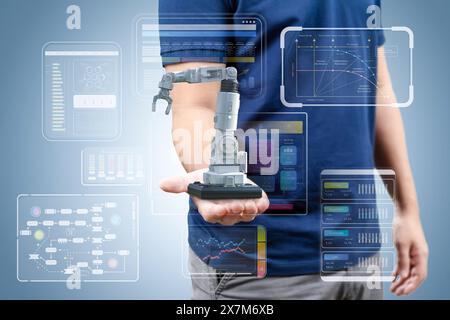 Concetto industriale dell'automazione con braccio robotico di controllo tecnico con display grafico Foto Stock