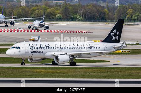 Monaco di Baviera, Germania, 6 aprile 2024: Un Airbus A320-214 della Lufthansa arriva in taxi alla pista dell'aeroporto di Monaco. L'aereo ha la livrea Star Alliance. (Foto di e. Foto Stock