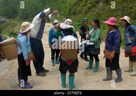 Un tizio caucasico viene molestato da donne locali per comprare souvenir, Cat Cat Village, Sapa, Lao Cai, Vietnam. Foto Stock