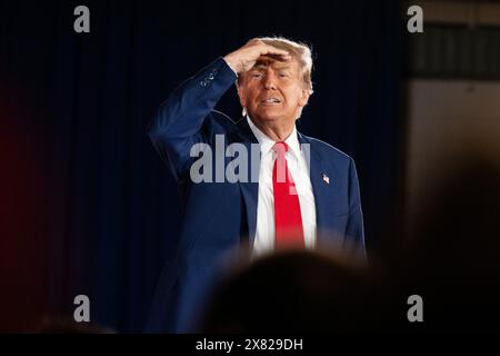 Donald Trump usa una mano per formare una visiera sopra gli occhi mentre guarda nella folla durante una manifestazione elettorale a Waukesha, Wisconsin, mercoledì 1° maggio Foto Stock