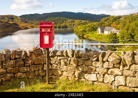 La cassetta postale del villaggio a Drumbeg. Un piccolo insediamento sulla costa di Assynt sulla rotta NC 500, con il pittoresco Loch Drumbeg subito dietro. Scozia Foto Stock