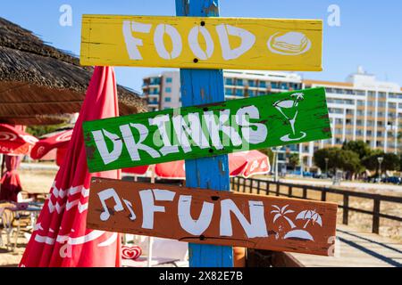 Insegna, cibo, bevande, divertimento sulla spiaggia di Monte Gordo, Algarve orientale, Algarve, Portogallo, Europa Foto Stock