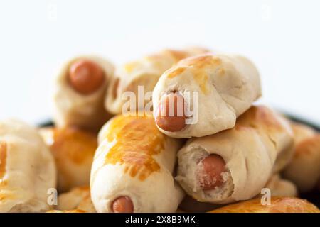 Salsicce nell'impasto su un piatto di ceramica sul tavolo. Foto Stock