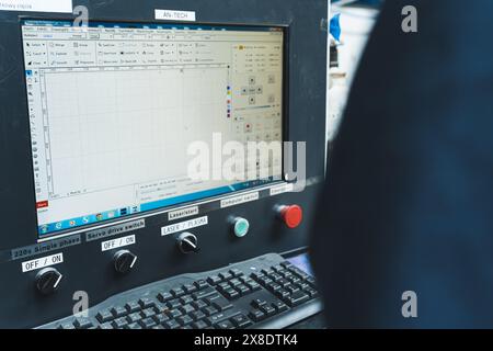 15.04.2024. Varsavia, Polonia. Operatore alla console di controllo della macchina di taglio laser CNC. Foto di alta qualità Foto Stock