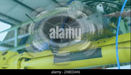 Due meccanici che indossano l'attrezzatura di sicurezza e fissano macchine di grandi dimensioni Foto Stock