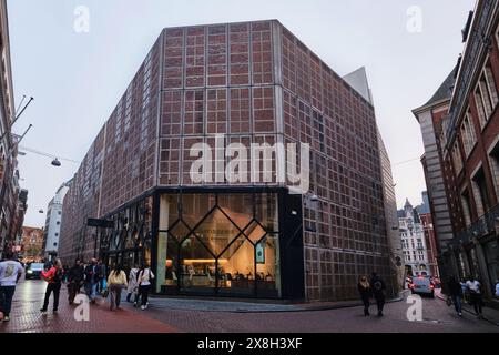 Paesi Bassi, Amsterdam - 6 aprile 2024: Pasticceria de Bijenkorf e veduta delle persone che camminano su via Warmoesstraat ad Amsterdam Foto Stock