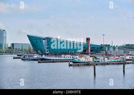 Paesi Bassi, Amsterdam - 8 aprile 2024: NEMO grande edificio a forma di nave di colore verde ospita il museo della scienza progettato da Renzo piano Foto Stock