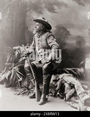 Buffalo Bill Cody, ritratto a figura intera, seduto, rivolto a sinistra, con fucile in mano - 1903 Foto Stock