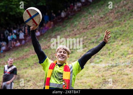Little Witcombe, Inghilterra, Regno Unito. 27 maggio 2024. Tom Kopke, 22 anni, di Monaco, in Germania, celebra la sua vittoria dopo la prima gara della Cooper's Hill Cheese Rolling and Wake, nei pressi di Brockworth, Gloucestershire. Crediti: Mark Hawkins/Alamy Live News Foto Stock