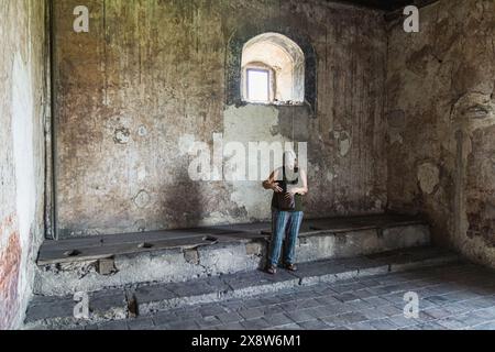 Yuriria, Messico, 26 maggio 2024: Donna in posa accanto alle latrine che i monaci usavano 400 anni fa. Foto Stock