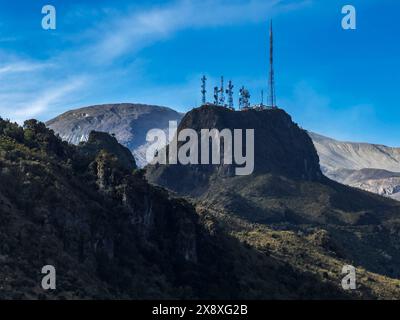 Torri cellulari sotto il picco delle Ande Nevado del Ruiz che raggiunge un'altezza di 17.457 piedi - Colombia Foto Stock