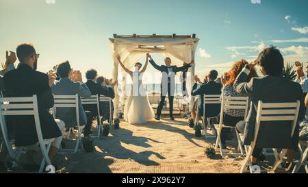 Splendida sposa e sposo durante una cerimonia nuziale all'aperto sulla spiaggia dell'oceano. Luogo perfetto per una coppia romantica che si sposa, scambia anelli, baciati e condividi celebrazioni con amici multietnici. Foto Stock