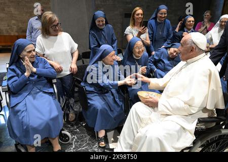 Roma, Italia. 29 maggio 2024. Papa Francesco incontra alcune suore prima del suo incontro con i sacerdoti romani ordinati per meno di dieci anni a Roma, Italia, il 29 maggio 2024. Papa Francesco continua la sua serie di incontri con il clero della sua diocesi, parlando con un gruppo di sacerdoti recentemente ordinati su questioni pastorali. L'incontro è stato ospitato dai Pi discepoli del Divino Maestro, un ordine di suore religiose, e il Papa ha ricevuto un affettuoso benvenuto dalle suore, tra saluti, doni e benedizioni. Foto di (EV) Vatican Media/ABACAPRESS. COM credito: Abaca Press/Alamy Live News Foto Stock