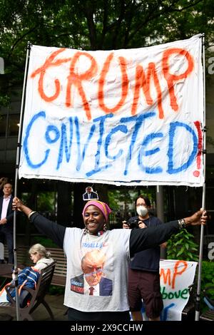 New York, New York, Stati Uniti. 30 maggio 2024. Una donna con un grande cartello che recita "Trump condannato" celebra fuori dal tribunale a seguito di un verdetto di colpevolezza nel processo penale contro l'ex presidente degli Stati Uniti Donald Trump. Crediti: Joseph Reid/Alamy Live News Foto Stock