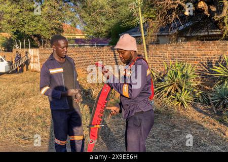 installazione di fibre ottiche all'aperto, due tecnici africani, in un'area residenziale Foto Stock