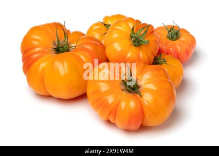 Un mucchio di pomodori arancioni freschi interi isolati su sfondo bianco da vicino Foto Stock