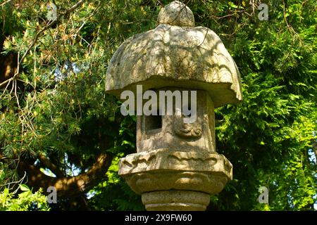 Una tradizionale lanterna toro giapponese in pietra collocata in un parco Foto Stock
