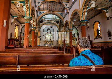 AGUADAS, COLOMBIA - 15 GENNAIO 2024: Donna anziana presso lo storico Tempio dell'Immacolata Concezione nel centro storico del patrimonio culturale di Foto Stock