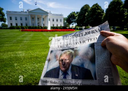 Un giornalista mostra un giornale "The Wall Street Journal" con il titolo "Trump condannato", fuori dalla Casa Bianca a Washington DC, Stati Uniti, venerdì 31 maggio 2024. BELGA FOTO JASPER JACOBS Foto Stock