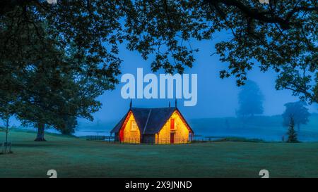 La casetta di Carton House Demesne si illumina di fronte ai colori blu nebbiosi delle ore la mattina di metà maggio Foto Stock