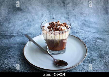 Latte caramello ghiacciato con panna montata e salsa al caramello, bevanda rinfrescante e dolce al caffè. Foto Stock