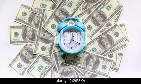 Time - concetto di denaro con orologio e dollaro in primo piano Foto Stock