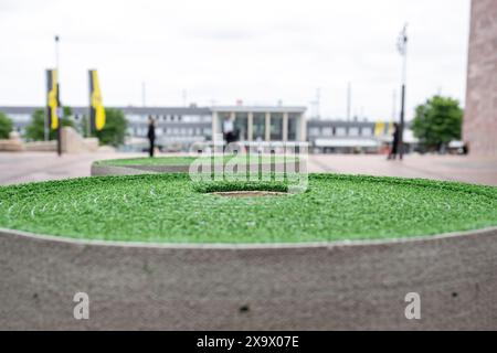 Dortmund, Germania. 3 giugno 2024. Calcio: Prima del Campionato europeo, nel centro della città viene allestito un tappeto erboso verde sui rulli. Durante i campionati europei, un tappeto attraversa il centro della città. Il percorso artificiale per il tappeto erboso inizia al Katharinentreppe presso la stazione principale e termina poco prima dello stadio. Il percorso verde ha lo scopo di fornire orientamento ai visitatori del torneo, mostrare loro la città e alleviare il peso dei trasporti pubblici. Credito: David Inderlied/dpa/Alamy Live News Foto Stock