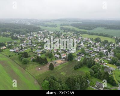 Tirpersdorf, Germania. 3 giugno 2024. Vista generale del villaggio di Tirpersdorf. (Sparato con un drone). Qui si è verificato un crimine violento con tre morti. Un uomo di 28 anni è stato arrestato sulla scena del crimine, secondo la polizia. Secondo gli investigatori, è il nipote o il figlio delle vittime. E' stato arrestato sulla scena senza resistenza. Credito: Bodo Schackow/dpa/Alamy Live News Foto Stock