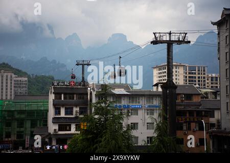 Ammira il paesaggio montano e il paesaggio urbano di Zhangjiajie con la funivia per i cinesi i viaggiatori stranieri visitano la grotta di Tianmen o la porta del Paradiso a Na Foto Stock