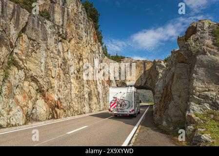 Motorhome attraversa un tunnel di roccia sulla strada del passo Susten nelle Alpi svizzere, Innertkirchen, Canton Berna, Svizzera Foto Stock