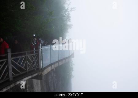 Glass Walkway o Grand Canyon Skywalk a picco sulla scogliera nel Tianmen National Forest Park per i cinesi i viaggiatori stranieri viaggiano a piedi durante la nebbia Foto Stock