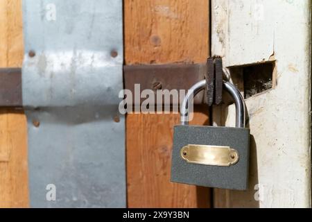Una porta di legno chiusa con una piccola serratura di metallo. Foto Stock