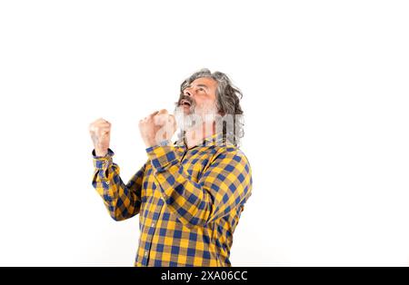 Un uomo eccitato che alza i pugni per festeggiare la vittoria Foto Stock