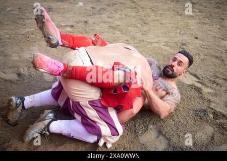 I giocatori si scontrano durante la semifinale tra le squadre bianche (Santo Spirito) e rosse (Santa Maria Novella) del calcio storico Fiorentino a Firenze (Italia), piazza Santa Croce, 1 giugno 2024. Il calcio storico Fiorentino, noto anche come calcio in costume, è un gioco di squadra con un pallone dalle origini remote e oggi una delle più antiche tradizioni fiorentine. Il gioco è una sfida tra i quattro quartieri della città. Le partite si giocano in costumi del XVI secolo e ogni anno viene organizzato un torneo che coinvolge i quattro quartieri storici della città Foto Stock