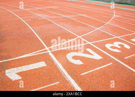 Una passerella rossa brillante con numeri bianchi stampati sulla linea di partenza. Foto Stock