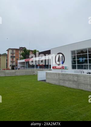 Cremona, Italia - 2 maggio 2024 supermercato moderno in un quartiere accogliente con prato verde e parcheggio, che offre comodi negozi. Fascino urbano con Foto Stock