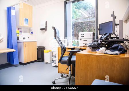 Ufficio medico con scrivania, sedia e attrezzature Foto Stock