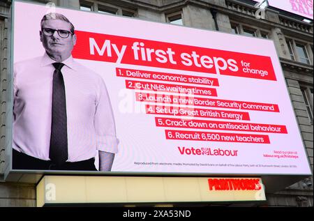 Cartellone elettronico a Manchester, Regno Unito, elenca il partito laburista "i miei primi passi per il cambiamento" con una foto di Sir Keir Starmer deputato Foto Stock