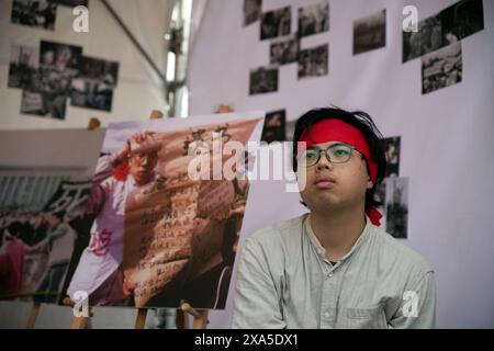Taipei, Taiwan. 4 giugno 2024. Un uomo in una tenda con foto scattate durante una veglia di Piazza Tiananmen per commemorare il 35° anniversario della repressione, noto anche come incidente del 4 giugno, alla Chiang Kai-shek Memorial Hall a Taipei, Taiwan. L'esercito cinese uccise molti manifestanti in piazza Tiananmen e nei dintorni di Pechino che chiedevano una riforma democratica nel 1989. Foto Stock