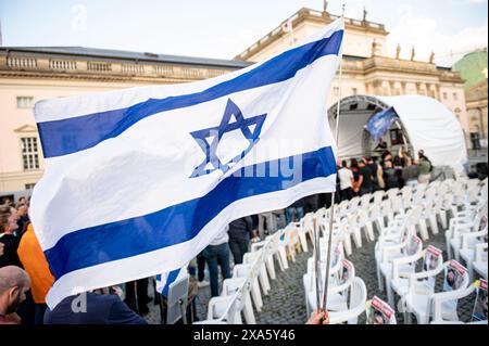 Berlino, Germania. 4 giugno 2024. Una bandiera israeliana vola all'evento di chiusura della "Piazza degli ostaggi di Hamas" a Bebelplatz. Dopo tre settimane, la "Piazza degli ostaggi di Hamas" sulla Bebelplatz di Berlino sta chiudendo. Secondo gli organizzatori, più di 15.000 persone hanno manifestato la loro solidarietà agli ostaggi israeliani di Hamas sin dalla ridenominazione simbolica di Bebelplatz il 16 maggio. Crediti: Fabian Sommer/dpa/Alamy Live News Foto Stock