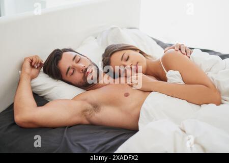 Coppia, coccola o dormi abbracciati a letto per romanticismo mattutino, amore e legame nel fine settimana. Relazione, uomo e donna che si sono messi insieme in casa per Foto Stock