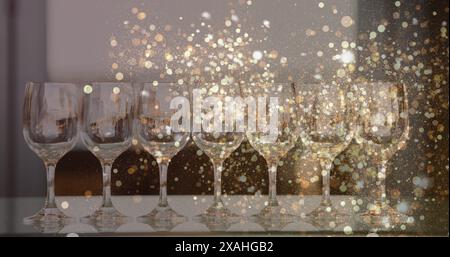 Immagine di luci dorate su bicchieri da vino vuoti Foto Stock