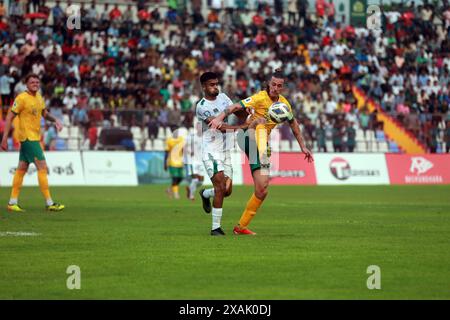 Il difensore del Bangladesh Saad Uddin (L) e il centrocampista dell'Australia Jackson Irvine (R) durante la partita di andata delle qualificazioni ai Mondiali FIFA a. Foto Stock