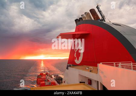 Marsiglia, Francia - 24 maggio 2024: Tramonto del sole dietro l'imbuto del traghetto Corsica linea, A Nepita, in partenza da Marsiglia in rotta per la Corsica Foto Stock