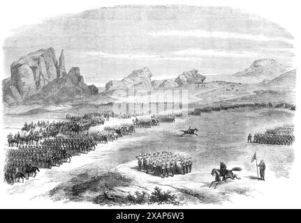 The Abyssinian Expedition: Review of the British Army on the Queen's birthday, at Senafe [in Eritrea], 1868. Dopo che Sir Robert (Napier) aveva superato la linea, prese posizione con il suo staff e con tutti gli ufficiali stranieri, e le truppe passarono davanti a lui. Il seguente ordine era: Il 3rd Dragoon Guards, sotto il colonnello Tower; la 12th Punjaub Cavalry; la Naval Rocket Brigade, sotto il capitano Fellowes; il Mule Mountain Train, sotto il colonnello Penn; i Royal Engineers, sotto il maggiore Pritchard; il 4th (King's Own), il 33rd e il 45th Reggimento, e il battaglione Beloochee... L'appearanc Foto Stock