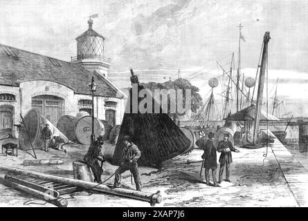 Trinity Buoy Wharf, Blackwall, 1868. Officina che ripara e mantiene i dispositivi per avvisare dei pericoli in mare. "...se una luce, una boa o un faro rotante viene resa inadatta all'uso a causa di condizioni meteorologiche o di incidenti, è possibile sostituirne immediatamente un'altra o riparare il danno senza indugio. Il lungofiume del molo...al deposito principale di Londra, da cui vengono inviate le provviste a tutti gli altri. E'... costruito nel punto in cui il fiume Lea si unisce al Tamigi... le boe sono per lo più costruite in ferro, e variano da 12 piedi. a 20 piedi Nel loro diametro più grande... sono d Foto Stock