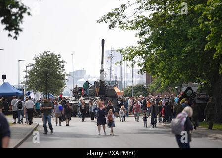 Rostock, Germania. 8 giugno 2024. I visitatori del Bundeswehr Day presso la base navale di Rostock-Hohe Düne ammirano l'obice semovente Panzerhaubitze 2000 in mostra. Crediti: Frank Hormann/dpa-Zentralbild/dpa/Alamy Live News Foto Stock